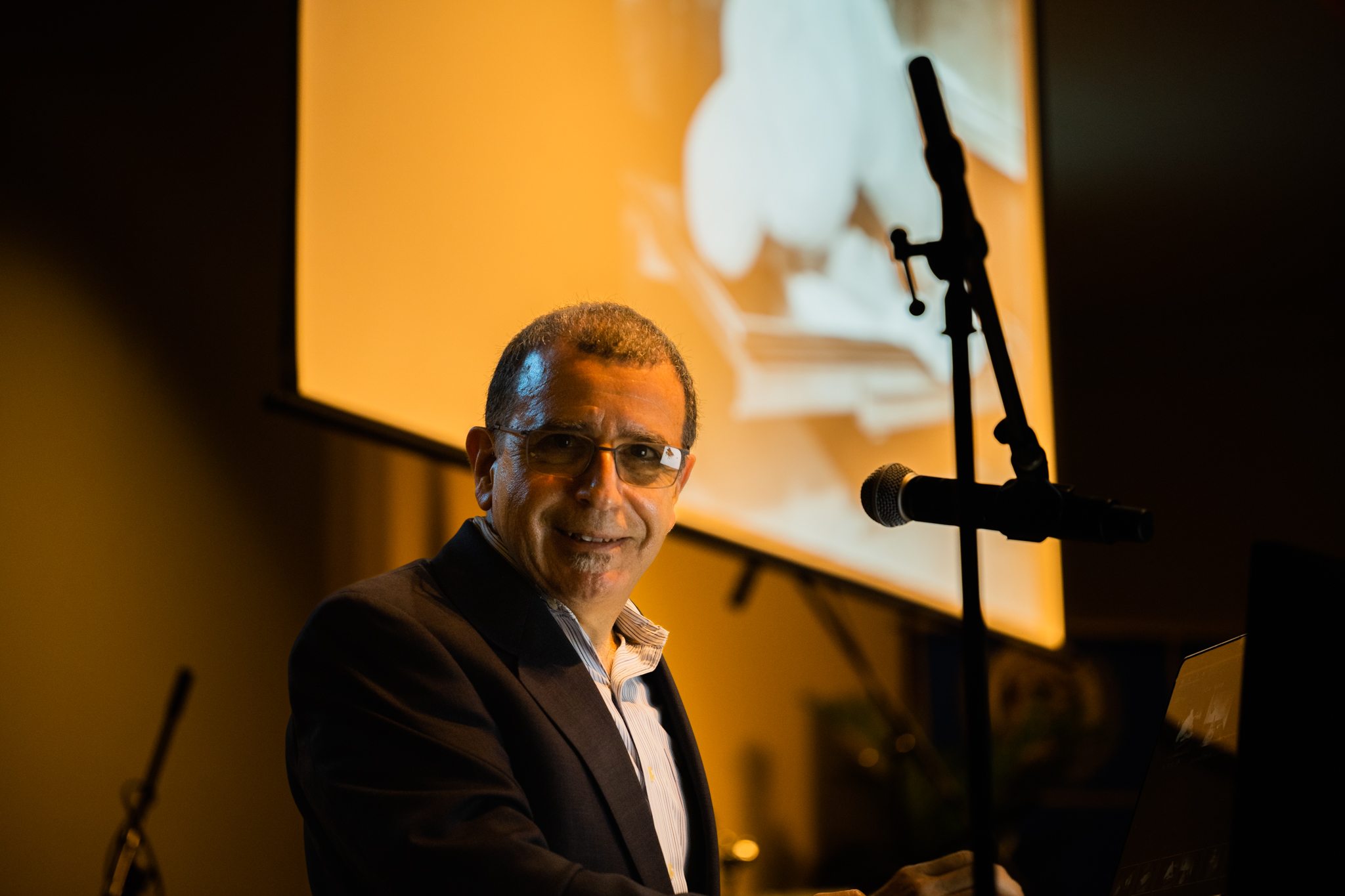 Speaker photographed in warm Orlando event lighting