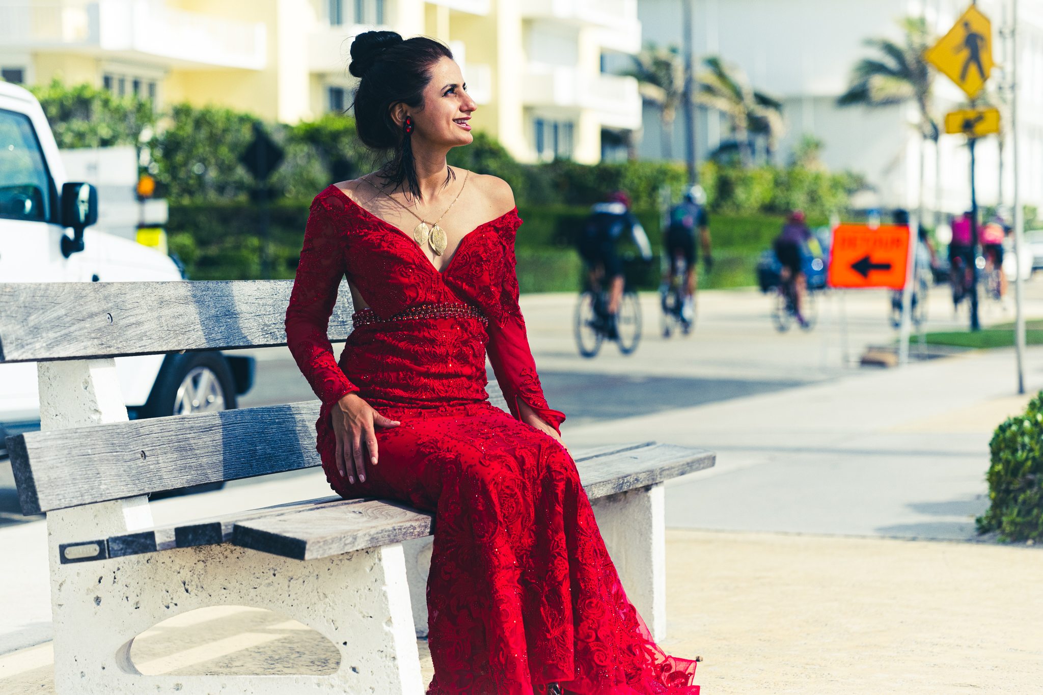 Athlete in red seated in an urban location